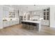 Spacious eat-in kitchen with an oversized island, modern stainless appliances and light gray cabinetry at 7304 Wexford Woods Ln, Wake Forest, NC 27587