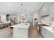 Spacious kitchen with an island, stainless steel appliances, open to living area and stairs to second floor at 7304 Wexford Woods Ln, Wake Forest, NC 27587
