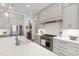 Modern kitchen with white countertops, stainless steel appliances, gray cabinets, and an open layout at 7304 Wexford Woods Ln, Wake Forest, NC 27587