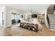 Cozy living room with fireplace, built-in shelving, sliding glass doors to an outdoor covered seating area at 7304 Wexford Woods Ln, Wake Forest, NC 27587