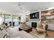 Inviting living room with a stone fireplace, hardwood floors and natural light with access to outdoor patio at 7304 Wexford Woods Ln, Wake Forest, NC 27587
