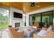 Relaxing screened-in back porch with a fireplace, ample seating and a wooded view at 7304 Wexford Woods Ln, Wake Forest, NC 27587