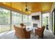 Inviting screened porch with a brick fireplace and comfortable seating at 7304 Wexford Woods Ln, Wake Forest, NC 27587
