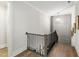 Bright staircase landing featuring hardwood floors and modern railing at 7304 Wexford Woods Ln, Wake Forest, NC 27587