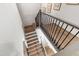 Bright stairway with wooden stairs and stylish black railings at 7304 Wexford Woods Ln, Wake Forest, NC 27587