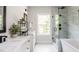 Contemporary bathroom featuring double vanity, white countertops, soaking tub, and tiled glass shower at 812 Ballaster Rd, Fuquay Varina, NC 27526