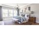 Relaxing bedroom with large windows, a comfortable bed, and modern decor at 812 Ballaster Rd, Fuquay Varina, NC 27526
