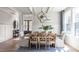 Bright dining room with a large table, modern lighting, and wood floors at 812 Ballaster Rd, Fuquay Varina, NC 27526
