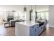 Open-concept kitchen with an island, stainless steel appliances, and views into the living spaces at 812 Ballaster Rd, Fuquay Varina, NC 27526
