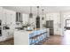 Bright kitchen with white cabinetry, an island with seating, and stainless steel appliances at 812 Ballaster Rd, Fuquay Varina, NC 27526