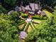 Stunning aerial view of a luxury home with manicured gardens and a circular driveway at 8200 Bromley Rd, Hillsborough, NC 27278