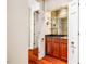 Charming bar area features custom cabinets, glass shelving, a sink, and stylish fixtures, perfect for entertaining at 8200 Bromley Rd, Hillsborough, NC 27278