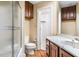 Bathroom featuring a shower, toilet, vanity with marble countertop and dark wood cabinets at 8200 Bromley Rd, Hillsborough, NC 27278