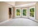 Sun-filled bedroom with neutral carpet and three large windows offering a tranquil view at 8200 Bromley Rd, Hillsborough, NC 27278