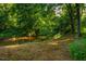 Scenic creek view with lush green trees, brush and lawn at 8200 Bromley Rd, Hillsborough, NC 27278