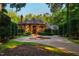 Stately brick home boasts manicured landscaping and circular driveway with fountain at 8200 Bromley Rd, Hillsborough, NC 27278