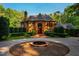Stately brick home boasts manicured landscaping and circular driveway with fountain at 8200 Bromley Rd, Hillsborough, NC 27278