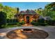 Stately brick home boasts manicured landscaping and circular driveway with fountain at 8200 Bromley Rd, Hillsborough, NC 27278