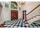 Elegant foyer features a striking black and white tile floor and grand staircase at 8200 Bromley Rd, Hillsborough, NC 27278
