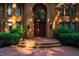 Grand entryway showcasing elegant brickwork, sconces, and a stately double door at 8200 Bromley Rd, Hillsborough, NC 27278