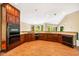 Spacious kitchen with ample counter space, terracotta tile flooring, and natural light from several windows at 8200 Bromley Rd, Hillsborough, NC 27278