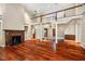 Spacious living room boasts a fireplace, hardwood floors, and soaring ceiling to the second floor at 8200 Bromley Rd, Hillsborough, NC 27278