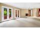 Expansive living room with multiple french doors offers ample natural light and seamless indoor-outdoor flow at 8200 Bromley Rd, Hillsborough, NC 27278