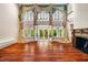 Living room showcasing a fireplace, hardwood floors, and French doors to the backyard at 8200 Bromley Rd, Hillsborough, NC 27278
