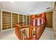 Spacious loft area features built-in bookshelves, rich wood trim, and elegant window treatments, creating a cozy and stylish retreat at 8200 Bromley Rd, Hillsborough, NC 27278
