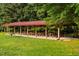 Covered picnic pavilion featuring multiple tables and a grill, ideal for outdoor dining at 8200 Bromley Rd, Hillsborough, NC 27278