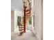 Unique spiral staircase with wooden steps offers a charming architectural detail and a view of surrounding green landscape at 8200 Bromley Rd, Hillsborough, NC 27278