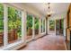Sun room featuring brick floors, brick columns and multiple windows providing natural light at 8200 Bromley Rd, Hillsborough, NC 27278