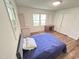 Bright bedroom with hardwood flooring, built-in storage, and natural light at 908 Valmet Dr, Durham, NC 27703