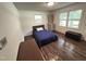Simple bedroom with hardwood floors, natural light, and a comfortable bed and storage at 908 Valmet Dr, Durham, NC 27703