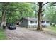 Exterior view showing a well-maintained yard and driveway leading to the home at 908 Valmet Dr, Durham, NC 27703