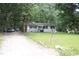 Charming single-story home with a well-maintained lawn and mature trees offering shade at 908 Valmet Dr, Durham, NC 27703