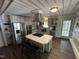 Well-equipped kitchen featuring stainless steel appliances, a center island, and updated cabinetry at 908 Valmet Dr, Durham, NC 27703
