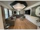 Elegant living room featuring hardwood floors, a comfortable sofa, and custom ceiling details at 908 Valmet Dr, Durham, NC 27703