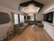 Spacious living room with hardwood floors, a large sofa, and stylish decor at 908 Valmet Dr, Durham, NC 27703