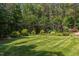 Expansive backyard featuring meticulously maintained lawn and a beautiful pergola at 1009 Margarets Ln, Raleigh, NC 27614