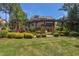 Beautiful backyard features a manicured lawn, landscaping, and a pergola-covered patio at 1009 Margarets Ln, Raleigh, NC 27614