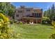 Back of the house with a deck, screened in porch, manicured yard, and colorful landscaping at 1009 Margarets Ln, Raleigh, NC 27614