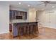 Basement bar with custom cabinetry and wine rack at 1009 Margarets Ln, Raleigh, NC 27614