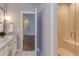 Bathroom with granite counters, tiled floors, a glass shower with bench, and a view to an adjacent room at 1009 Margarets Ln, Raleigh, NC 27614