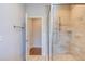 Bathroom showcasing a glass shower with bench and rain shower head plus access to another room at 1009 Margarets Ln, Raleigh, NC 27614