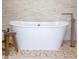 Chic bathroom with a freestanding tub, stone accent wall, and stylish fixtures at 1009 Margarets Ln, Raleigh, NC 27614