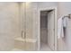 Bright bathroom featuring a glass shower with bench seating and a tiled wall at 1009 Margarets Ln, Raleigh, NC 27614