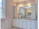 Bright bathroom featuring a white vanity with granite countertops, marble flooring, and decorative lighting at 1009 Margarets Ln, Raleigh, NC 27614