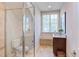 Bathroom featuring a glass shower with bench, tile floor, and natural light from the window at 1009 Margarets Ln, Raleigh, NC 27614