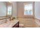 Charming bathroom with mosaic tile accent, framed mirror, wood vanity and natural light at 1009 Margarets Ln, Raleigh, NC 27614